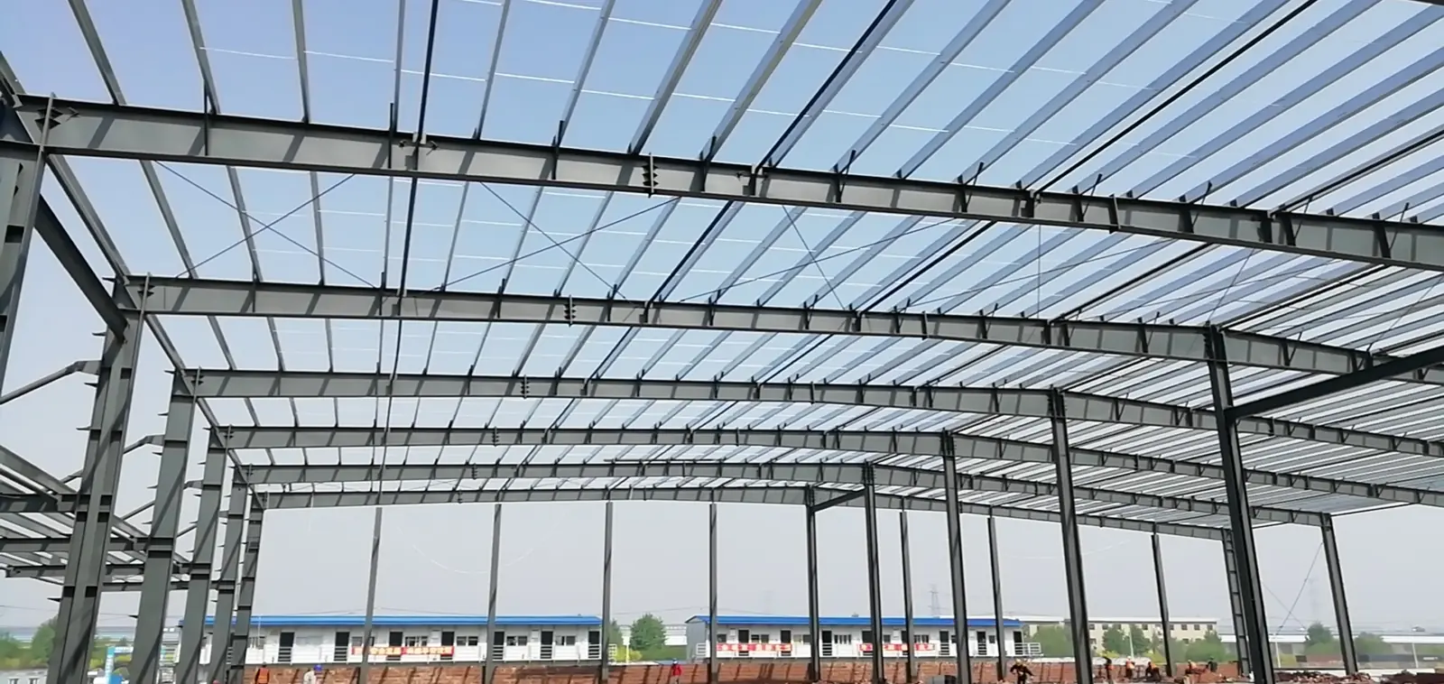 Steel rafters and roof structure inside an industrial building.
