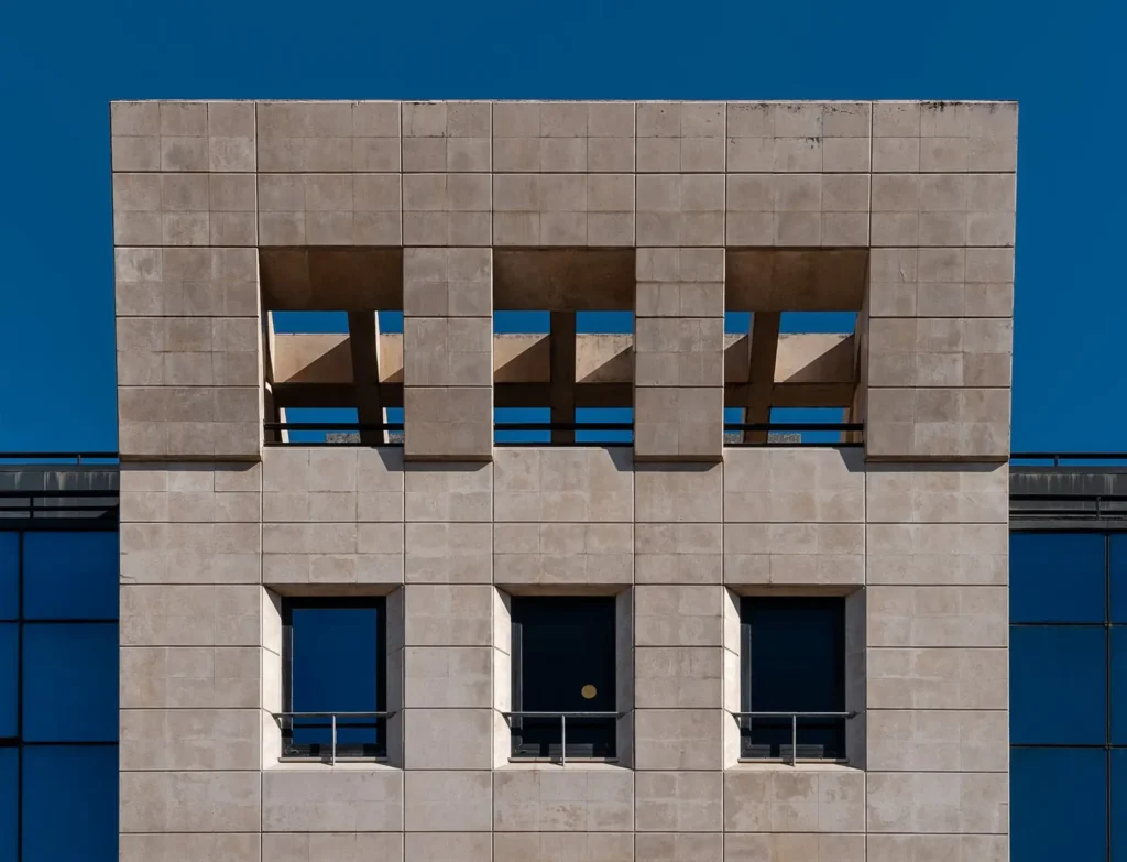 Stone facade and window details of an office building.